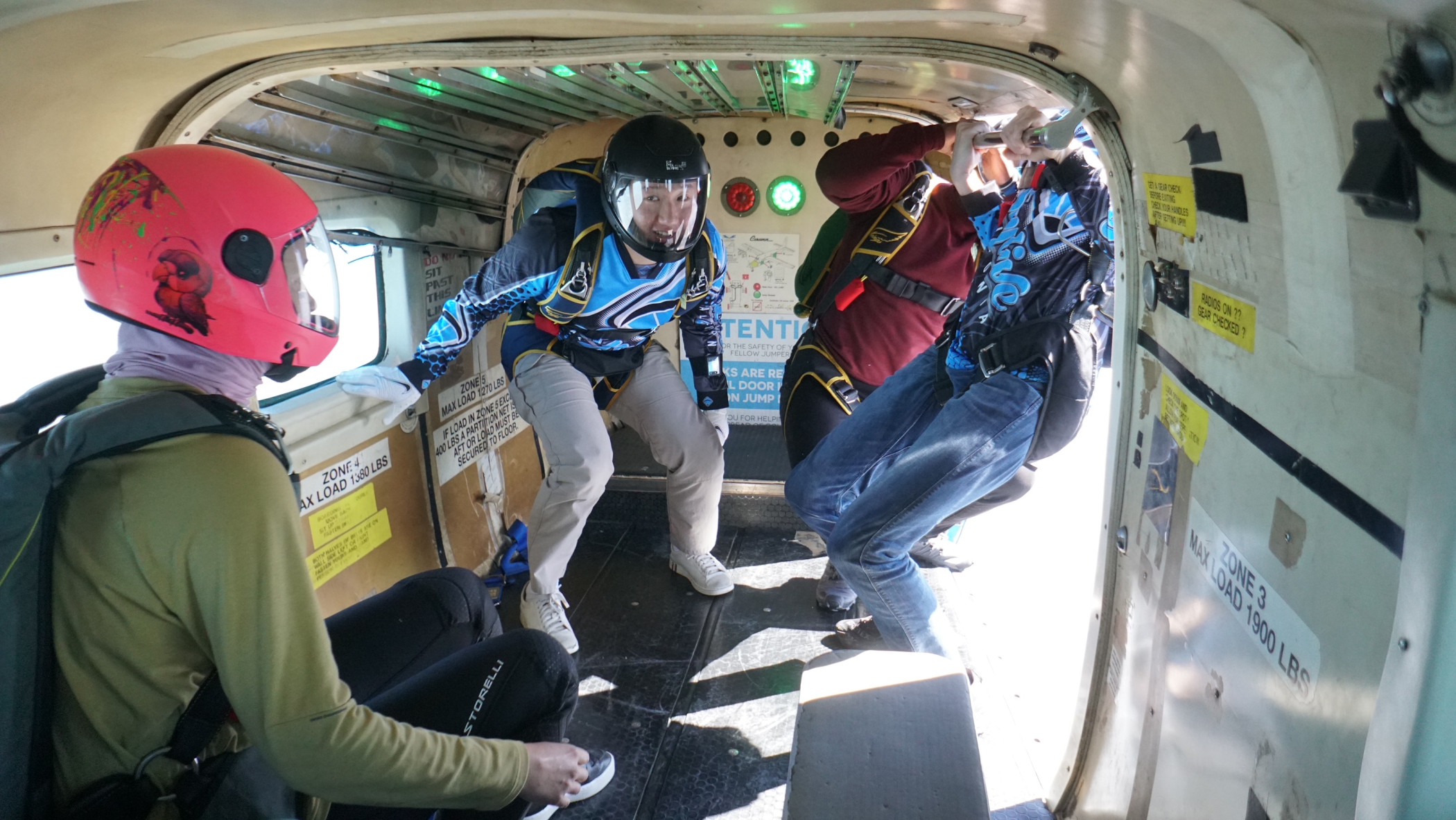 Skydivers preparing for exit inside the plane at Skydive California, a premier skydiving center near San Francisco.