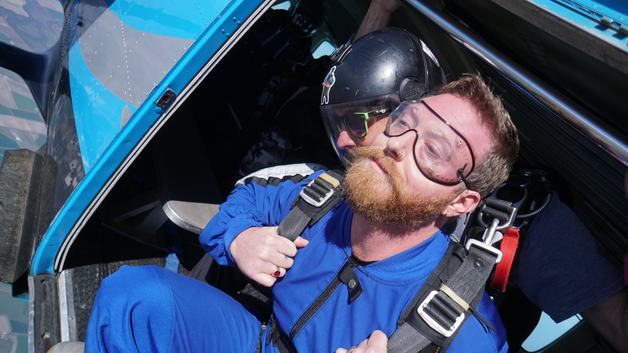 Tandem skydiver sitting at the open airplane door moments before jumping over Skydive California near San Francisco.