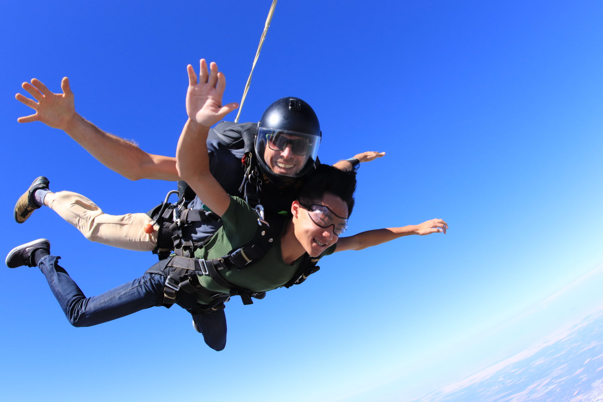 A tandem skydiving pair skydiving at 13,000 feet at Skydive California