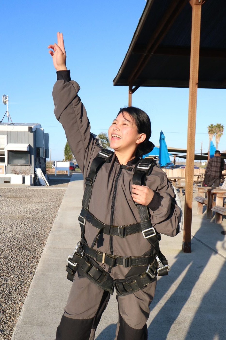 Skydiving in San Francisco area—Excited passenger pointing skyward, ready for the big jump.