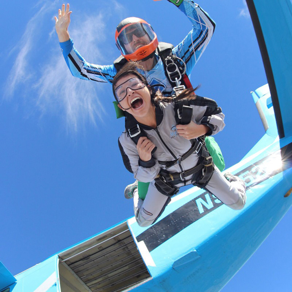 Tandem skydiver leaping from Skydive California aircraft into free fall.